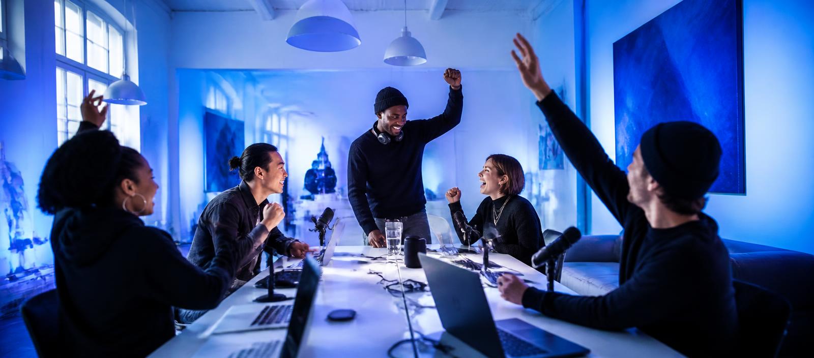 Agency team celebrating a new podcast client in a studio